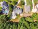 An aerial view shows the home nestled among mature trees and landscaped yard at 1004 Fairway Seven, Villa Rica, GA 30180