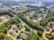 Panoramic aerial view displays neighborhood featuring mature trees and sidewalks at 1004 Fairway Seven, Villa Rica, GA 30180