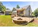 Stone patio with a built-in fire pit and seating area offers a cozy outdoor space at 1004 Fairway Seven, Villa Rica, GA 30180