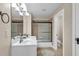 Bathroom with double sink vanity, modern lighting, and walk-in shower at 1004 Fairway Seven, Villa Rica, GA 30180