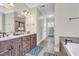 Bathroom features double sinks, wood cabinets, neutral tile, and soaking tub at 1004 Fairway Seven, Villa Rica, GA 30180