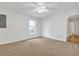 Bright bedroom featuring carpet floors, a ceiling fan, and a window with blinds for natural light at 1004 Fairway Seven, Villa Rica, GA 30180