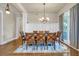 Dining room featuring wood flooring, a statement chandelier, and natural light from a large window at 1004 Fairway Seven, Villa Rica, GA 30180