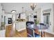 Open-concept dining room and kitchen area with hardwood floors and classic decor at 1004 Fairway Seven, Villa Rica, GA 30180