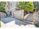 Side view of the house featuring a stone foundation, yard, and a stairway at 1004 Fairway Seven, Villa Rica, GA 30180