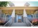 Charming front entrance with a glass door, stone pillars, hanging lights and plants at 1004 Fairway Seven, Villa Rica, GA 30180