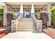 Elegant front entrance featuring stone pillars, stairs, and landscaping at 1004 Fairway Seven, Villa Rica, GA 30180