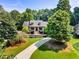 Inviting home with a long driveway, manicured lawn, and lush landscaping at 1004 Fairway Seven, Villa Rica, GA 30180
