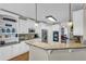 Open kitchen with granite countertops, white cabinets, stainless appliances and hardwood floors at 1004 Fairway Seven, Villa Rica, GA 30180