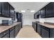 Kitchen with black cabinets, stainless appliances, and modern fixtures at 1004 Fairway Seven, Villa Rica, GA 30180