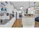Bright kitchen featuring granite countertops, white cabinets, stainless appliances, and hardwood floors at 1004 Fairway Seven, Villa Rica, GA 30180