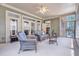 Relaxing sunroom with wicker furniture, ceiling fan and lots of natural light at 1004 Fairway Seven, Villa Rica, GA 30180
