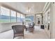 Bright sunroom with wicker furniture, ceiling fan and multiple windows at 1004 Fairway Seven, Villa Rica, GA 30180