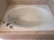 Oval bathtub with chrome fixtures and beige tile surround at 2119 Gorman Se Grv # 126, Atlanta, GA 30316
