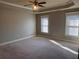 Spacious carpeted bedroom with two windows and ceiling fan at 2119 Gorman Se Grv # 126, Atlanta, GA 30316