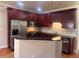 Kitchen with dark wood cabinets and stainless steel appliances at 2119 Gorman Se Grv # 126, Atlanta, GA 30316