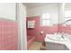 Bathroom with pink tile, a bathtub, and a vanity with marble countertop at 4032 E Hilda Cir, Decatur, GA 30035