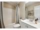 Clean bathroom with tub/shower combo, white vanity and neutral decor at 300 Huntington St, Covington, GA 30016