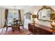 Formal dining room showcases elegant furniture and ample natural light at 300 Huntington St, Covington, GA 30016