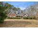 Charming brick home with a well-manicured lawn and mature trees for a serene setting at 300 Huntington St, Covington, GA 30016