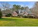 Charming brick home featuring a well-manicured lawn and mature landscaping at 300 Huntington St, Covington, GA 30016