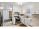Updated kitchen featuring white cabinetry and stainless steel appliances at 300 Huntington St, Covington, GA 30016