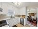Modern kitchen featuring white cabinets and stainless steel appliances at 300 Huntington St, Covington, GA 30016