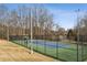 Community tennis court, ready for a match with well-maintained surface and surrounded by trees at 300 Huntington St, Covington, GA 30016