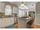 Kitchen with white cabinets, granite counters, and island at 105 Ardenlee Dr, Peachtree City, GA 30269