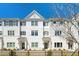 White three-story townhouses with black windows and a black fence at 1756 Evenstad Way, Smyrna, GA 30080