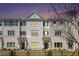 Attractive three story townhome at dusk with warm lighting at 1756 Evenstad Way, Smyrna, GA 30080