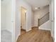 Light-filled hallway with wood-look floors and half bathroom at 1756 Evenstad Way, Smyrna, GA 30080