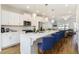 Open concept kitchen with white cabinets, island, and gold lighting at 1756 Evenstad Way, Smyrna, GA 30080