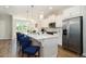 Modern kitchen with white cabinets, quartz countertops, and stainless steel appliances at 1756 Evenstad Way, Smyrna, GA 30080