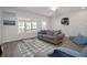 Living room with hardwood floors, large windows, and comfy sofas at 1756 Evenstad Way, Smyrna, GA 30080