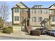 Front view of three story townhome with attached garage and landscaping at 2071 Cobblestone Ne Cir, Brookhaven, GA 30319