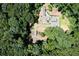 Home nestled in a wooded area, driveway, bridge at 3244 Stillhouse Rd, Atlanta, GA 30339