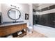 Modern bathroom with a freestanding tub, dark tile, and a large vanity at 3244 Stillhouse Rd, Atlanta, GA 30339