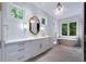 Bright bathroom with white vanities and a large mirror at 3244 Stillhouse Rd, Atlanta, GA 30339