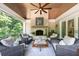 Relaxing covered porch with fireplace, wicker furniture, and ceiling fan at 3244 Stillhouse Rd, Atlanta, GA 30339