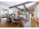 Open dining room with hardwood floors, exposed beams, and view to kitchen at 3244 Stillhouse Rd, Atlanta, GA 30339