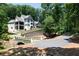 Luxury home with driveway, bridge and landscaping at 3244 Stillhouse Rd, Atlanta, GA 30339