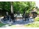 Stone fire pit with black Adirondack chairs in a wooded backyard setting at 3244 Stillhouse Rd, Atlanta, GA 30339