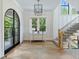 Bright foyer with herringbone floors, arched door, and staircase at 3244 Stillhouse Rd, Atlanta, GA 30339