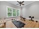 Bright home gym with wood floors, large windows, and various exercise equipment at 3244 Stillhouse Rd, Atlanta, GA 30339
