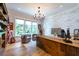 Spacious home office with wood desk and brick feature wall at 3244 Stillhouse Rd, Atlanta, GA 30339