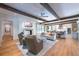 Open living space with hardwood floors, exposed beams, and kitchen view at 3244 Stillhouse Rd, Atlanta, GA 30339