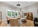 Relaxing music room with comfortable seating, built-in shelving, and hardwood floors at 3244 Stillhouse Rd, Atlanta, GA 30339