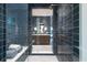Walk-in shower with dark blue tile and built-in bench at 3244 Stillhouse Rd, Atlanta, GA 30339
