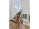Elegant staircase with wood railing and herringbone wood floors at 3244 Stillhouse Rd, Atlanta, GA 30339